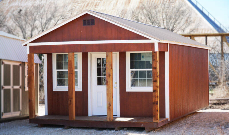 Cabinette shed with a beautiful stained wood finish and white trim, offering a functional and stylish storage solution