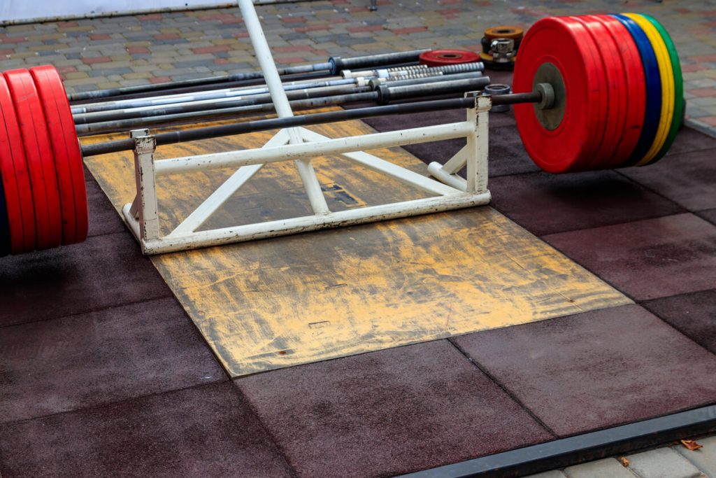 Deadlift station with bar and weights, a fundamental exercise for building strength and muscle in the lower body.