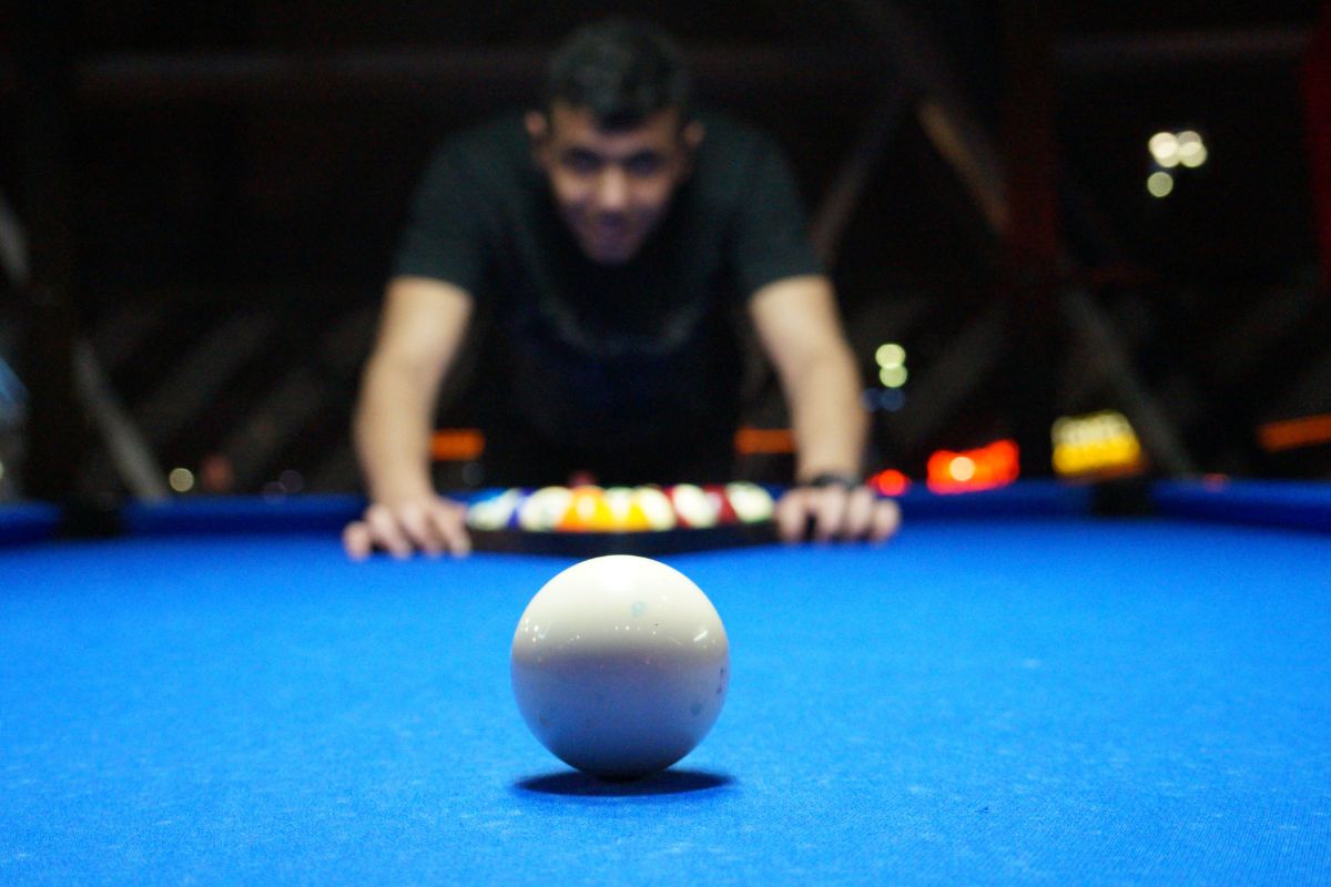 man setting up a pool table 