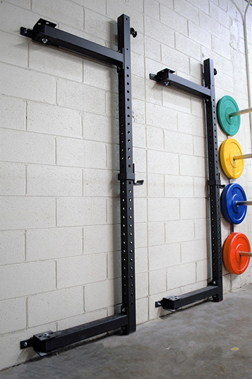 Foldable squat rack with hanging weight bars, providing a versatile option for strength training exercises