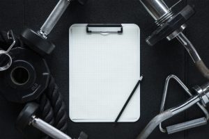 Gym background with clipboard mockup notepad and Fitness equipment for personal training
