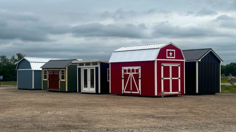 a lofted barn, garden shed, and studio shed lined up next to each other