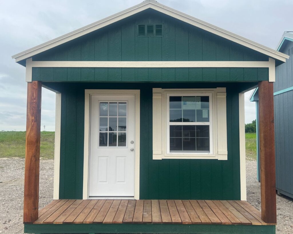 green cabinette shed with two wood columns and white trim
